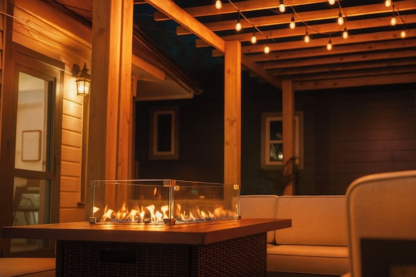 View from the outdoor furniture at night with the fire table ACTIVATED