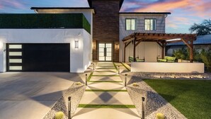 A modern two-story house with a garage, a covered patio, and a well-maintained lawn. - Modern Arcadia Family Luxury Compound Htd Pool & Spa, Outdoor Kitchen & Fire Pit (Phoenix)