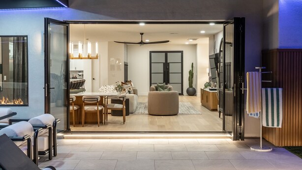 An open-plan living area with a dining table, sofas, and a ceiling fan. - Modern Arcadia Family Luxury Compound Htd Pool & Spa, Outdoor Kitchen & Fire Pit (Phoenix)
