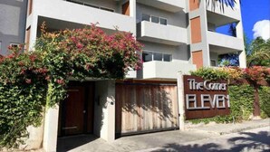 A multi-story building with a sign reading "The Corner Eleven" and a gated entrance. - Centrally located Simpson bay 1bdr apt (1-4A) (Simpson Bay)