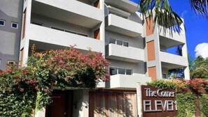 A multi-story hotel with a sign reading "The Corner Eleven." - Blue Sky Apt in the middle of Simpson Bay-GENERATOR(1-3A) (Simpson Bay)
