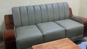 A grey leather sofa with wooden armrests and a matching wooden coffee table. - 6Cape Guest House Kawanda  (Kampala)