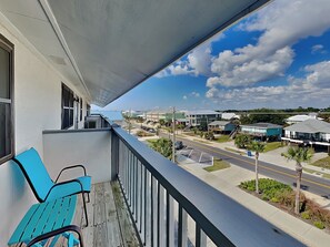 A balcony with a view of a street and buildings. - Ocean Echo #303 (Gulf Shores)