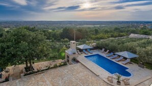 A pool area with lounge chairs and a stone deck. - Six Bedroom Holiday House With Pool (Benkovac)