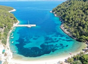 A coastal area with a pier, boats, and a beach. - Apartments Stiniva Hvar - One Bedroom Apartment With Terrace (A1) (Brusje)