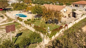 A residential property with a swimming pool, stone walls, and a view of distant mountains. - Holiday House Šimun - Three bedroom Holiday house with pool (Stankovci)