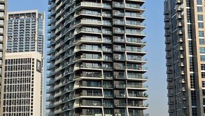 A tall, modern building with balconies and a sign reading "BINGHATTI". - Chic 1BR with Private Terrace & Burj Khalifa Skyline View | 4 Guests (Dubai)