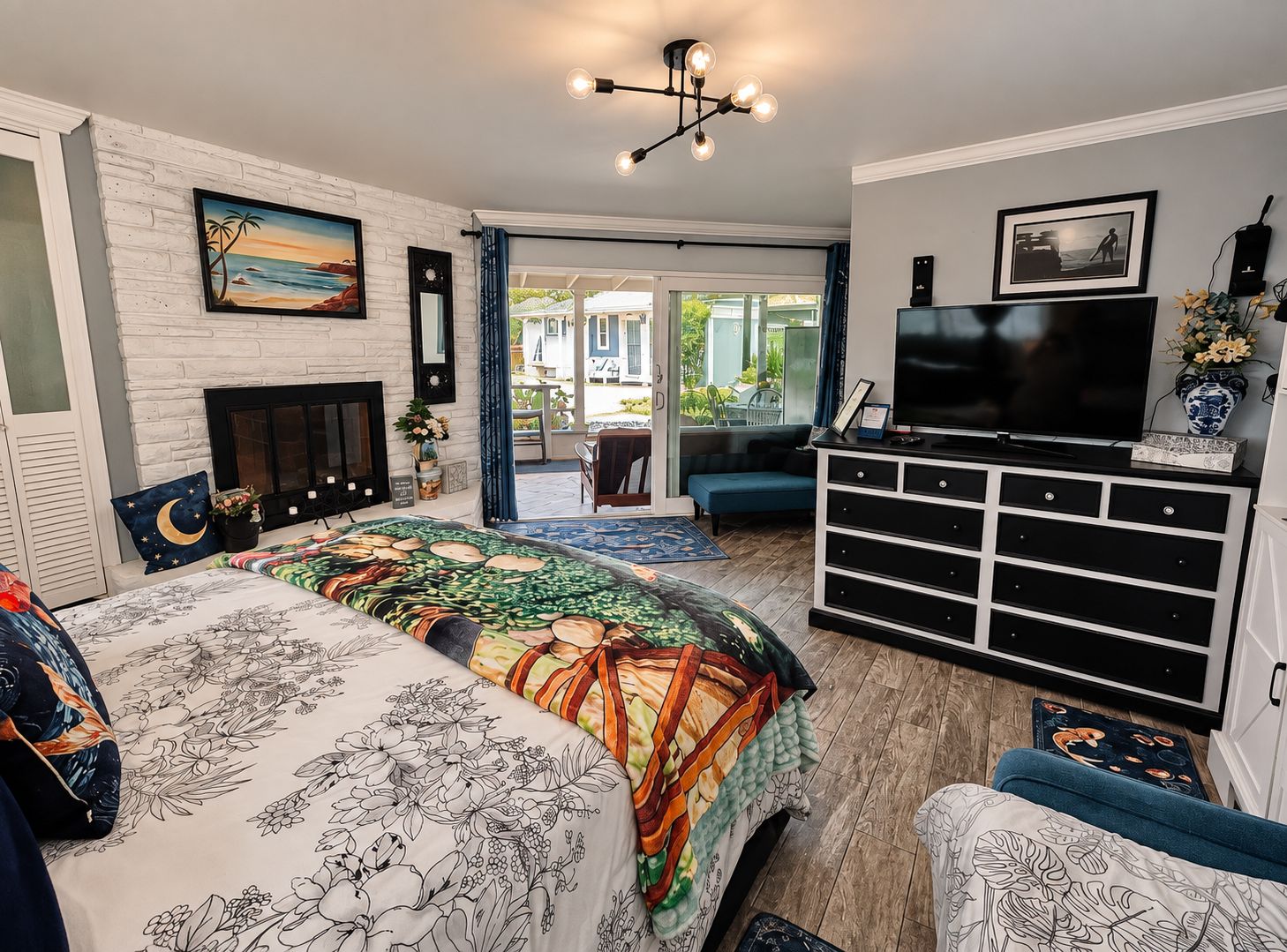 Quarto com cama, televisão, penteadeira e lareira.