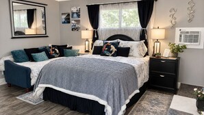 A bedroom with a bed, bedside tables, a mirror, and a window with curtains. - THE KOI PONDS RETREAT 3k Sqft OUTDOORS + Kitchen, 2Bd 1 Ba Mstr Suite & Casita (Fullerton)