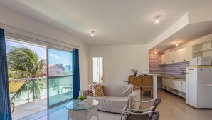 A modern apartment with a balcony, a dining area, and a kitchen. - Apart With 2 Bedrooms, 150m From the Beach Kvd0201 (Caucaia)