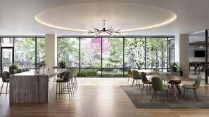 A modern dining area with a central island, large windows, and a chandelier. - Hyatus Curated Residences Everett (Everett)