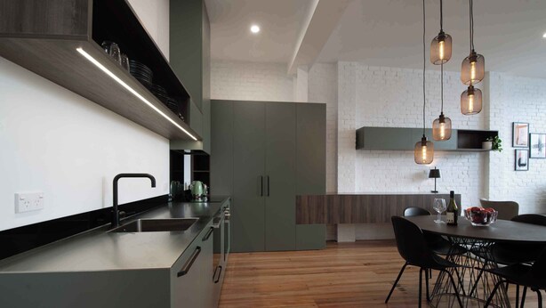 A modern kitchen with a built-in island, stainless steel appliances, and pendant lighting. - Wow! Luxury inner-city two bedroom apartment (Dunedin)