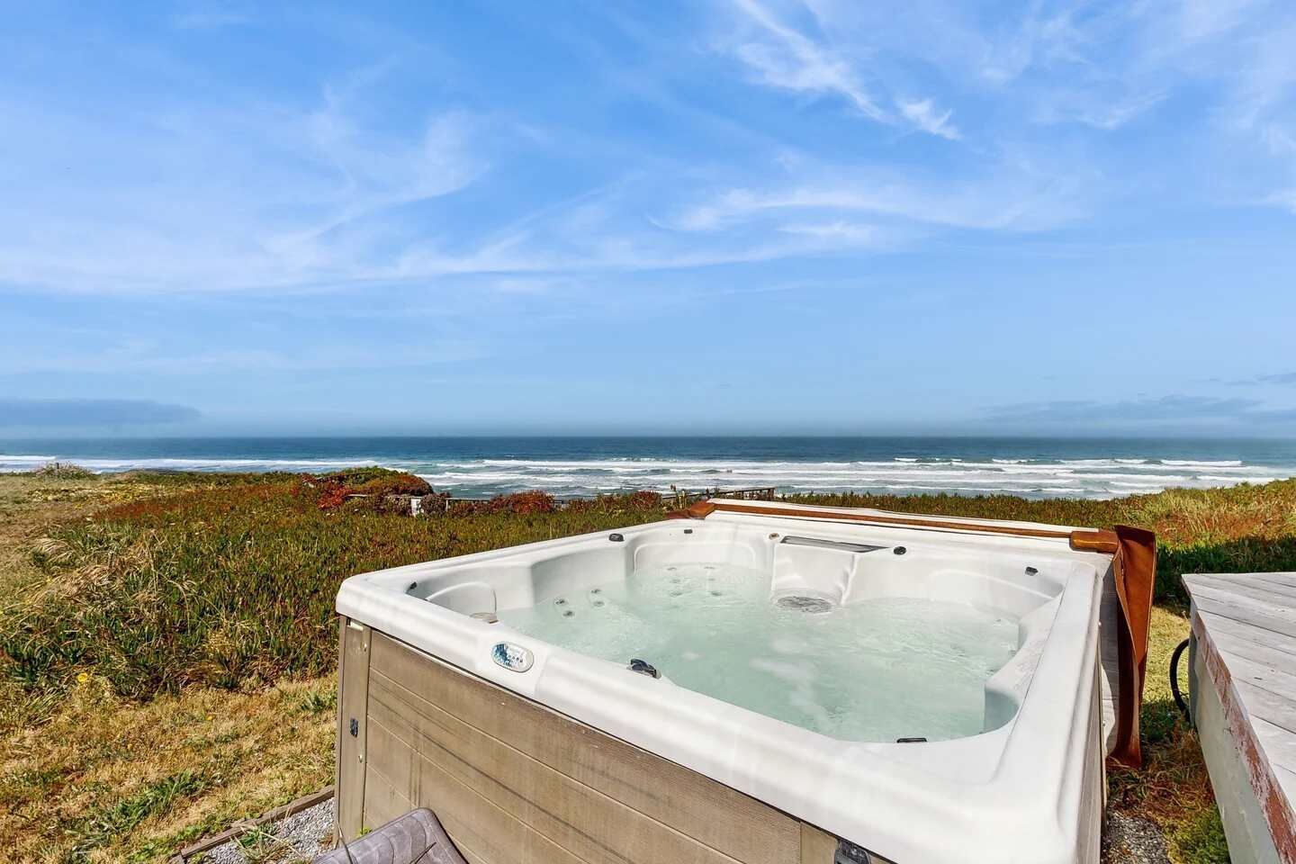 A hot tub with a view of the ocean.