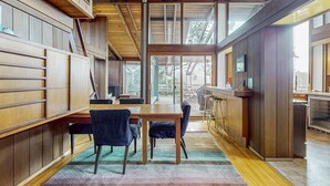 A modern kitchen with wooden cabinetry, a large island, and a view through the windows. - Oceanfront Blufftop Home - Wide Deck & Water Views (Elk)