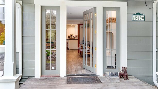 A house entrance with a number sign '45120' on the wall, a welcome mat, and a small decorative horse statue.