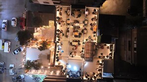 An aerial view of a hotel with multiple dining areas, outdoor seating, and a parking lot. - Pyramids Spiritual Gate (Giza)