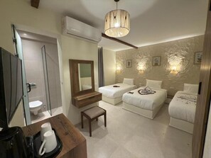 A hotel room with two beds, a wooden bench, a coffee maker, a mirror, and a chandelier. - Pyramids Spiritual Gate (Giza)