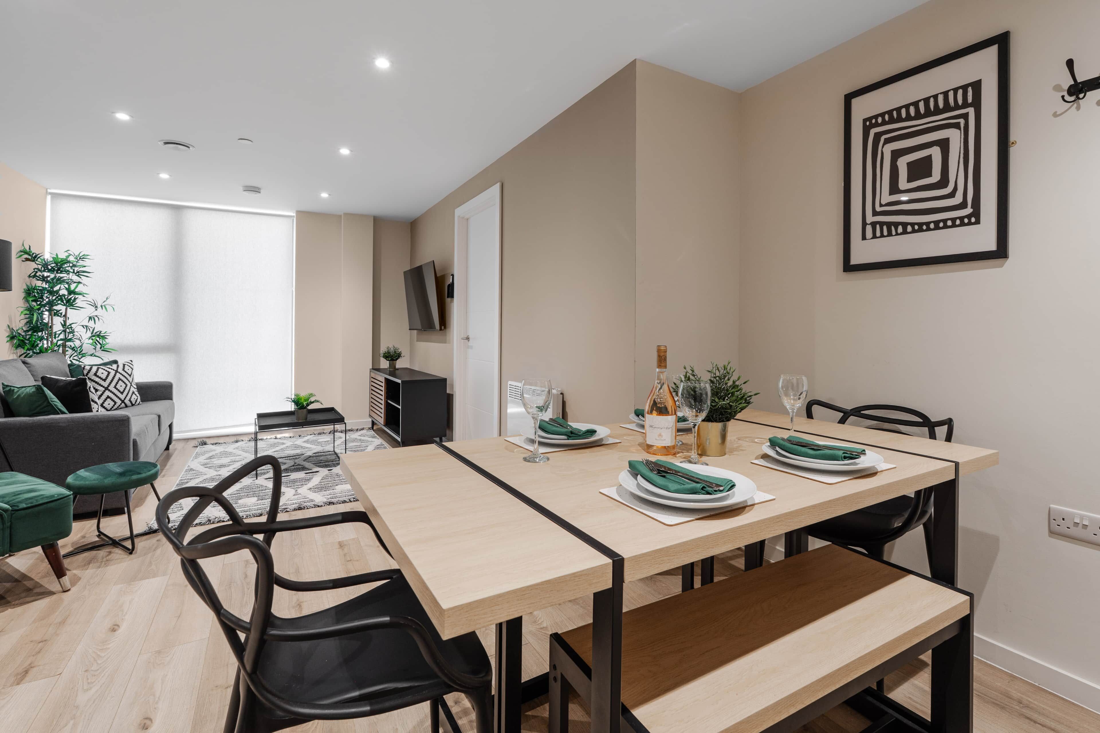 A modern dining area with a wooden table, black chairs, and a minimalist decor.