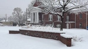 A brick building with a snow-covered entrance and a sign reading "BAY VILLAGE MUNICIPAL BUILDING." - Cozy & Modern 3-Bed Getaway Near Lake Erie (Bay Village)