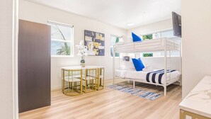 A bunk bed with pillows, a round table with chairs, a small plant, and artwork on the walls. - J. Lovely & Spacious 3BR Home by Universal with Patio + Parking (Los Angeles)