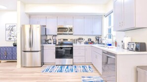 A modern kitchen with stainless steel appliances, a microwave, oven, and a toaster. - J. Lovely & Spacious 3BR Home by Universal with Patio + Parking (Los Angeles)