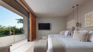 A modern bedroom with a large bed, a flat-screen TV, and a balcony with a view of greenery. - Marea Surf Residences: 4BR, Private Pool & Golf Cart (Punta Mita)