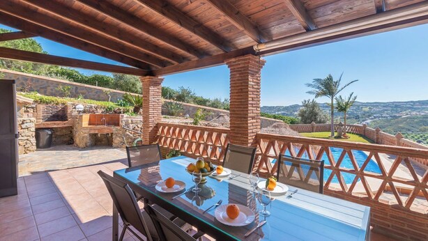 An outdoor dining area with a table set for two, overlooking a pool and a scenic view. - El Acebuche Mijas by Ruralidays (Málaga)