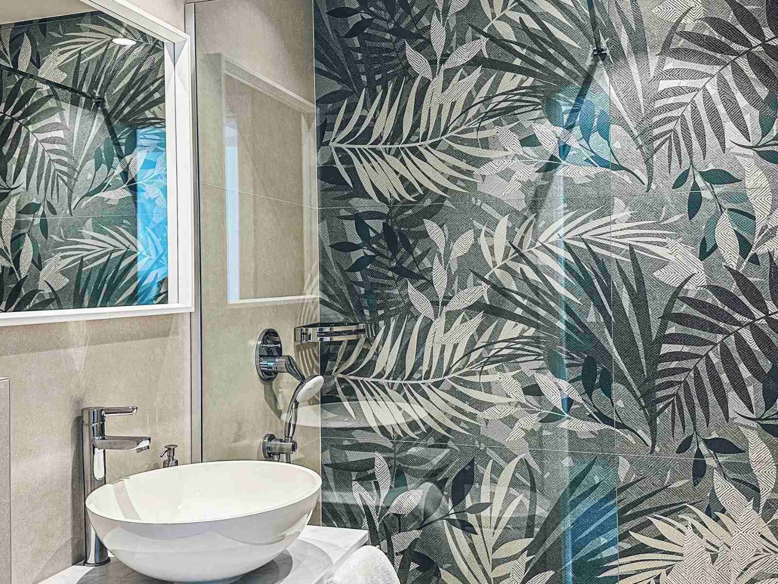 A bathroom with a white sink, a mirror, and a shower.