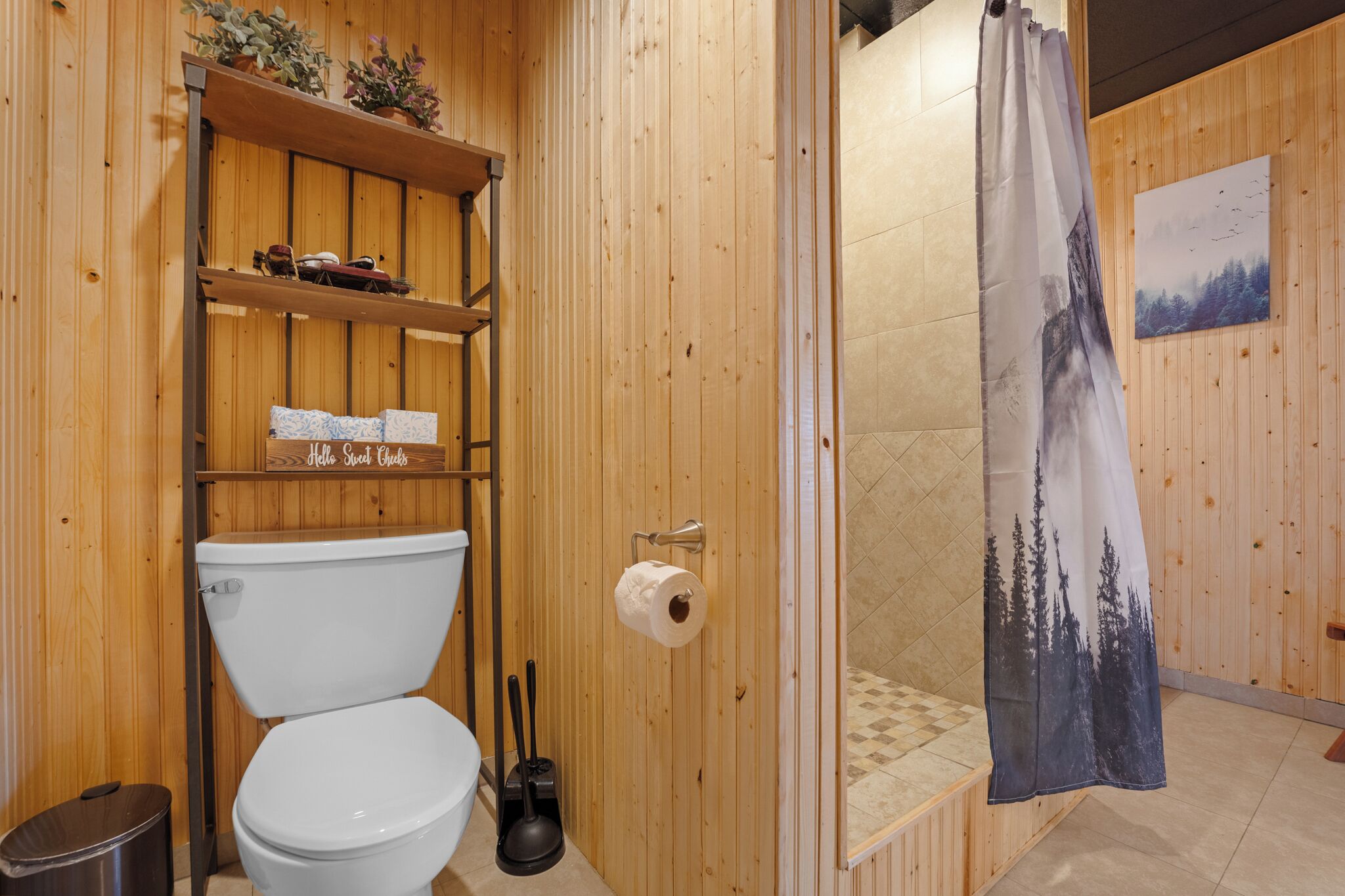 A wooden bathroom with a toilet, shelves, and a shower curtain.