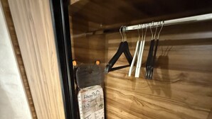A wooden interior with a hanging rack, a package of toilet paper, and a box on the floor. - Marrakech 2 Bedroom Brown Luxury Apartment (Marrakech)
