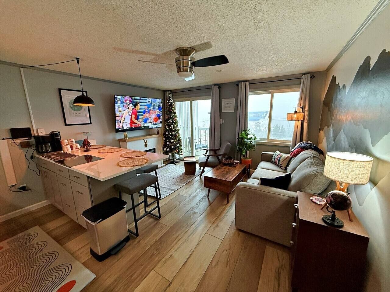 A modern living space with a kitchen, dining area, and seating area.