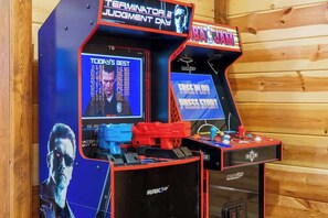 Arcade machines with 'Terminator Judgment Day' and 'NBA Jam' titles, and a 'Today's Best' scoreboard. - 8-Bedroom Smoky Mountain Cabin with Indoor Pool, Theater & Game Room (Sevierville)