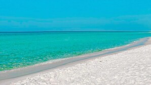A beach with clear turquoise water and white sand. - Exclusive beachfront: 2BR condo, pool, hot tub (Miramar Beach)