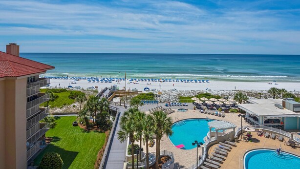 A resort with a pool, beach, and ocean view. - Beachfront condo with Gulf views & pool access (Miramar Beach)