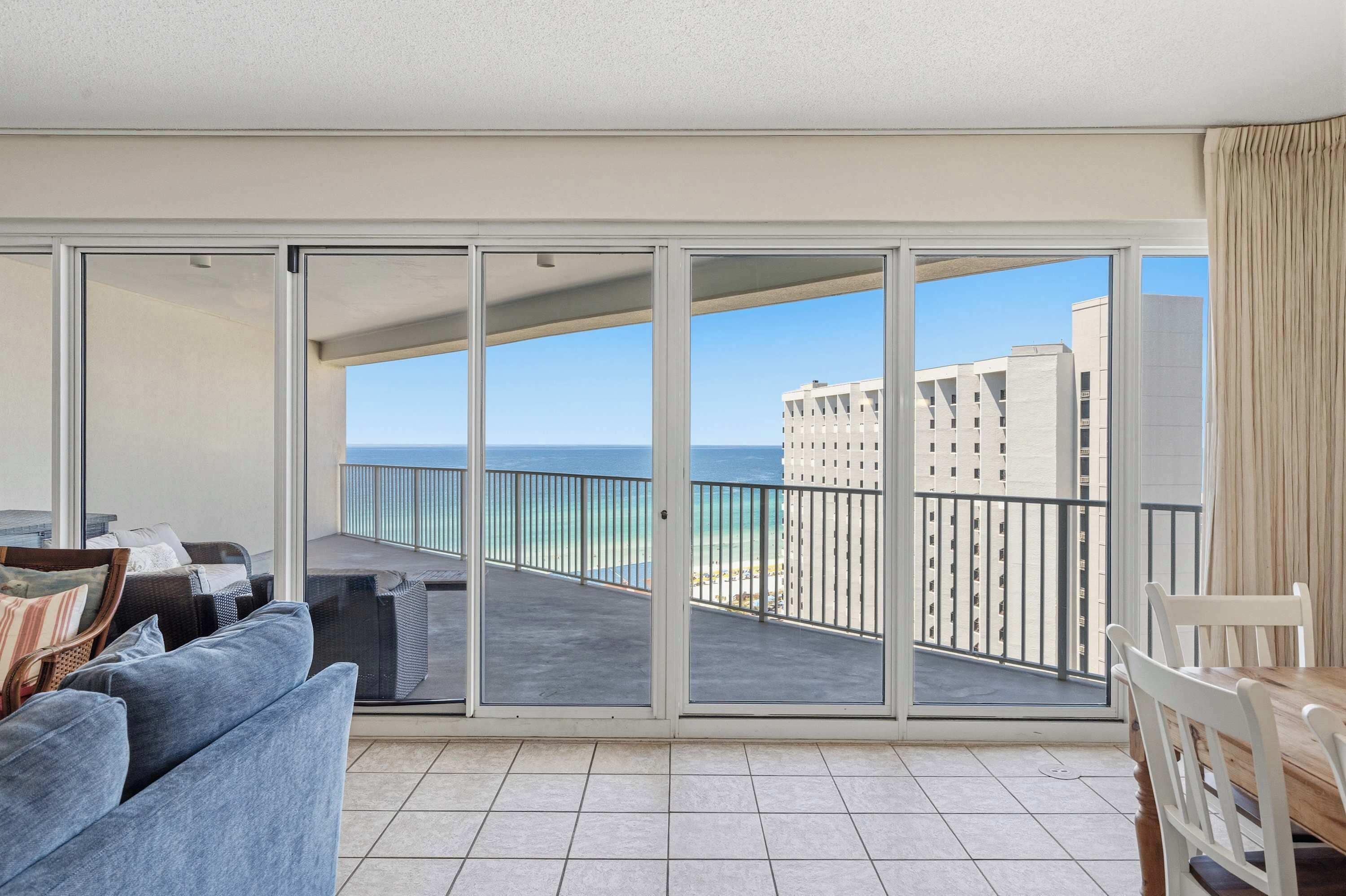 A balcony with a view of the ocean and a building.
