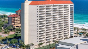 A high-rise hotel with multiple balconies, a red roof, and a view of the ocean. - Exclusive Gulf Views, Private Balcony (Miramar Beach)