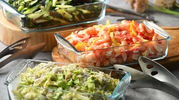 Three glass dishes with various food items.