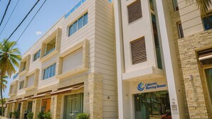 A hotel with a modern design, featuring a prominent sign for 'Cobarreto Morning Breeze'. - Stunning  Beach Front Condo, King Bed, Stunning Beach and Ocean Views (Cabarete)