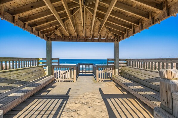 A wooden beach pavilion with a view of the ocean. - Ocean's Outside: Relaxing Oceanfront Escape (Kill Devil Hills)