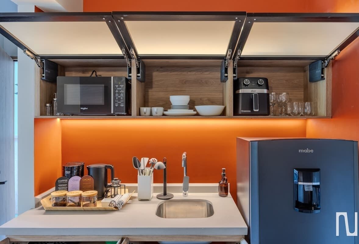 Fridge, microwave, coffee/tea maker, cookware/dishes/utensils