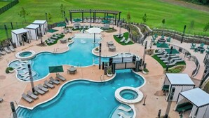 A large outdoor swimming pool with multiple sections and lounge areas. - Eagle`s Vista · Heated Pool, Stunning Views, Hot Tub & Game Room - Sleeps 30! (Broken Bow)