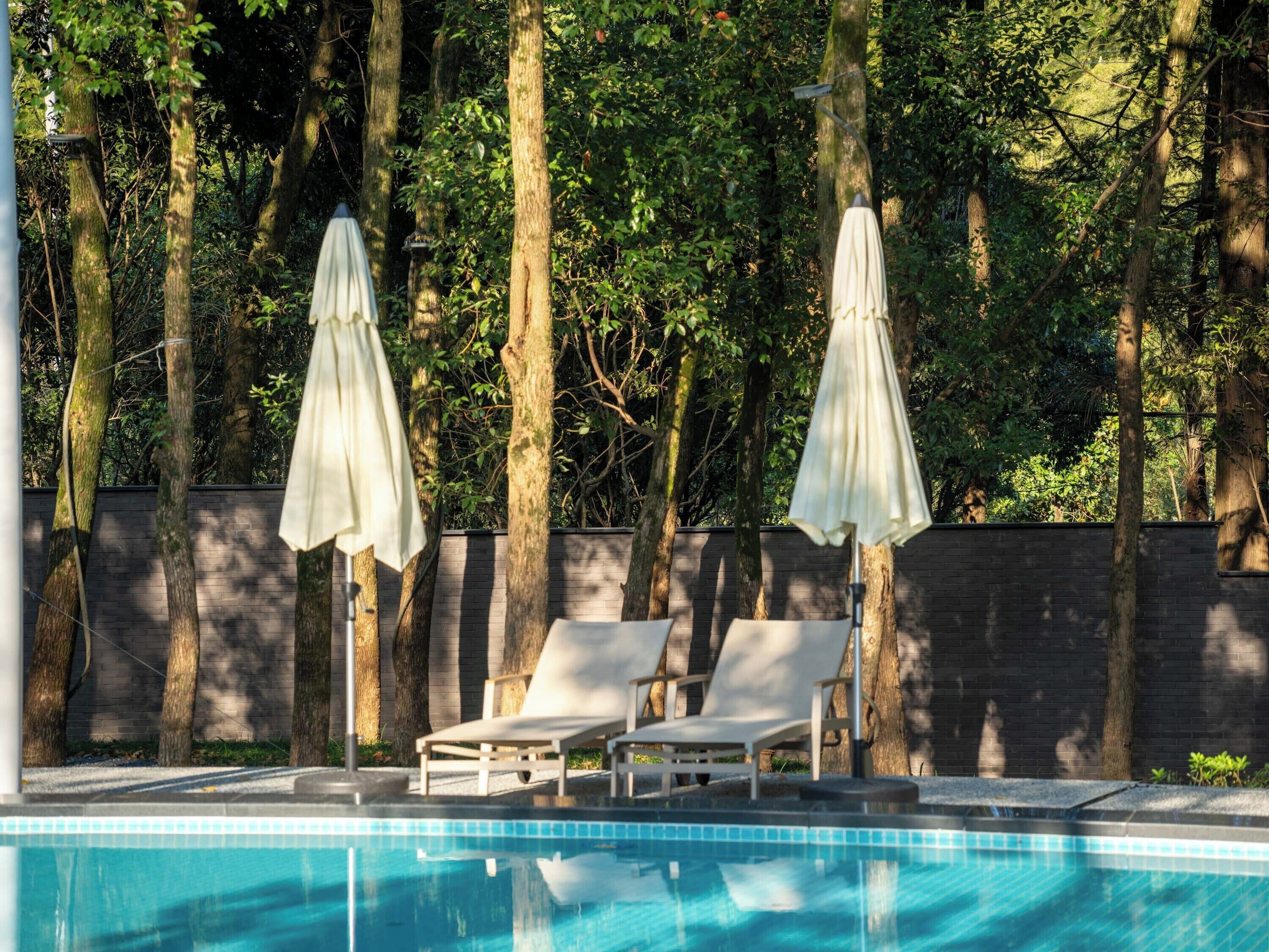 Seasonal outdoor pool, open 9:00 AM to 8:00 PM, pool umbrellas
