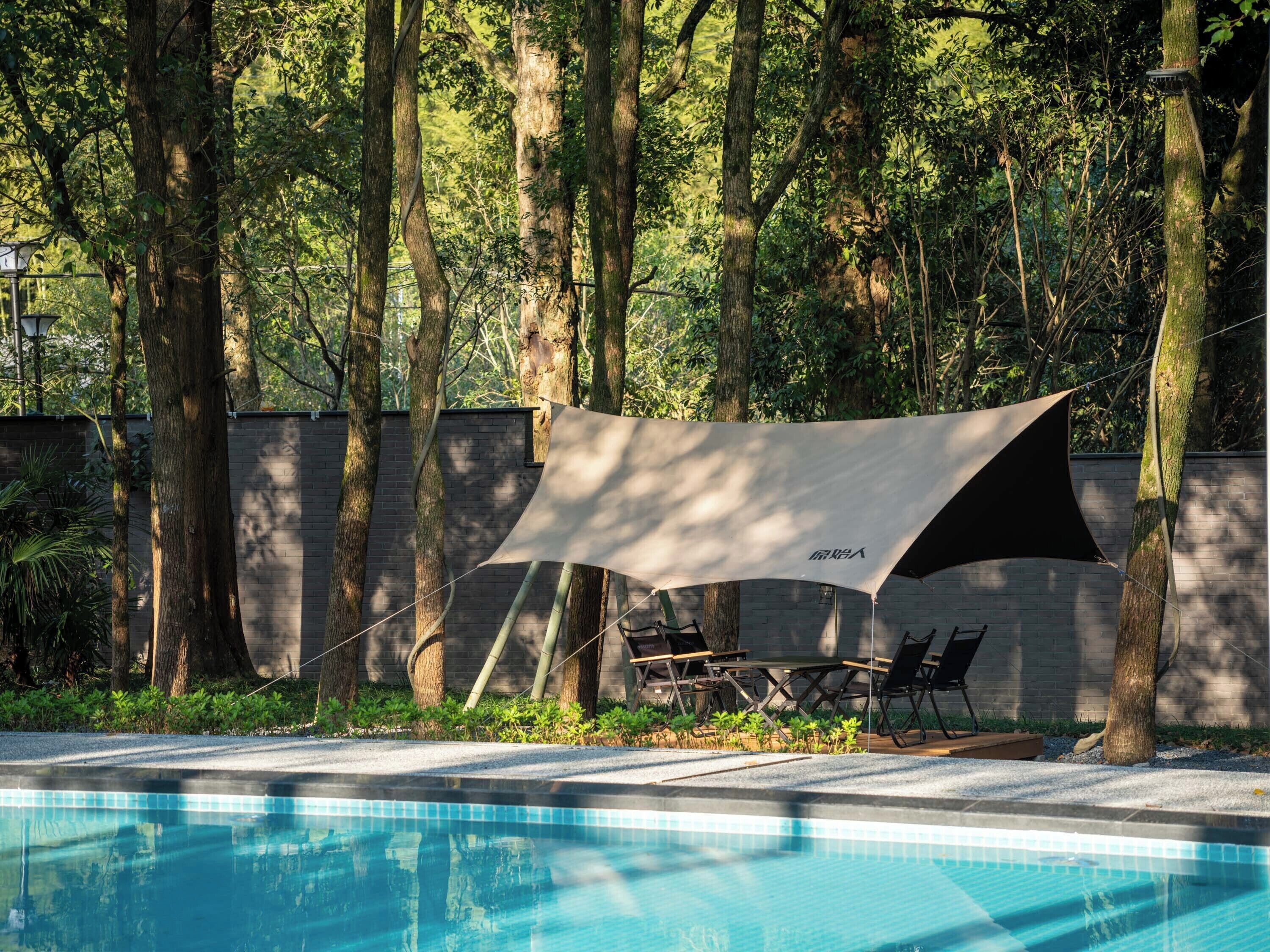 Seasonal outdoor pool, open 9:00 AM to 8:00 PM, pool umbrellas