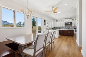 A spacious kitchen with a central island, large windows, and a view of the outdoors. - Peaceful Horizons with Views, 2 Hot Tubs, Seclusion, Games! (Gatlinburg)