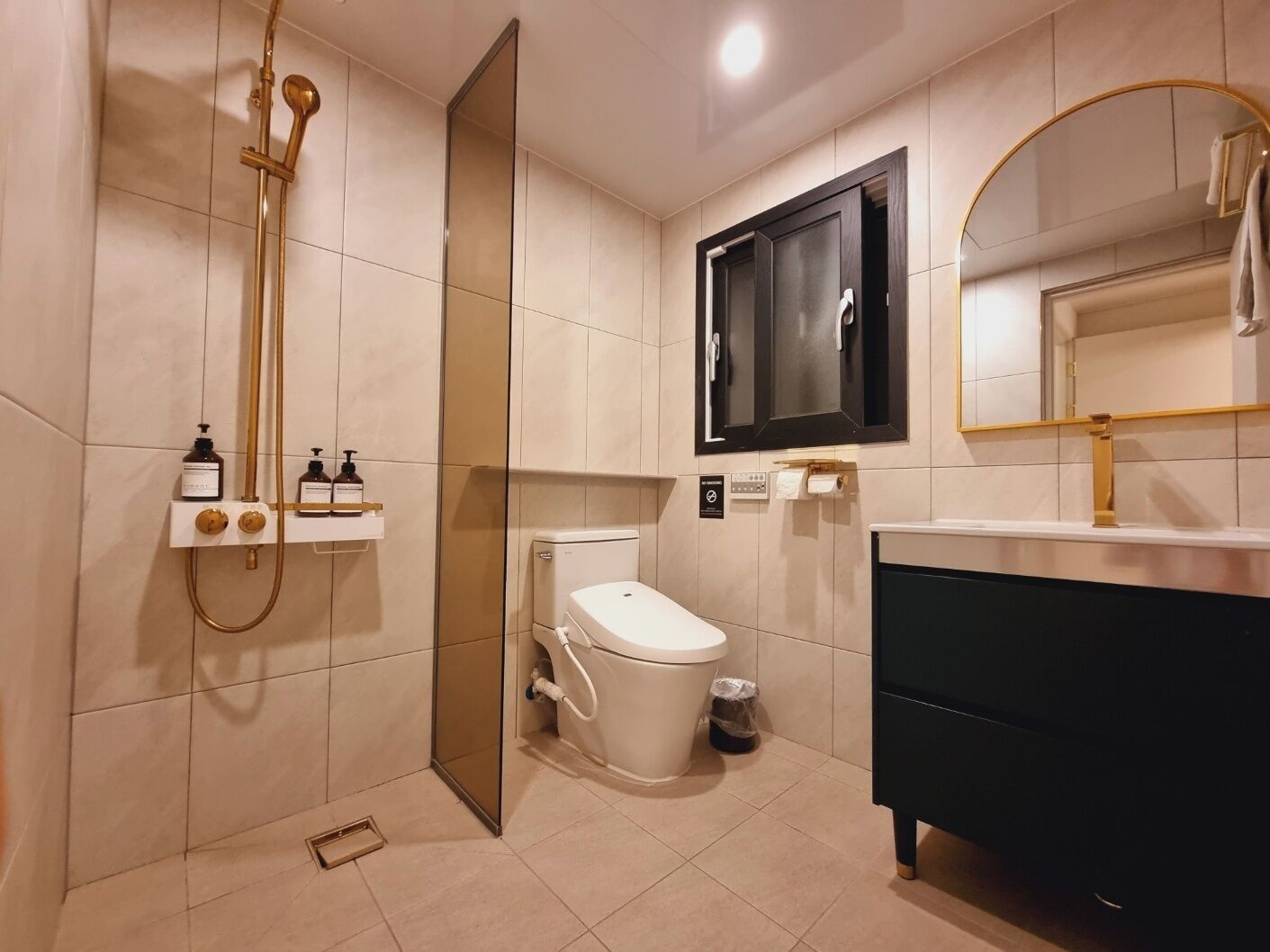 A modern bathroom with a toilet, bidet, and vanity.