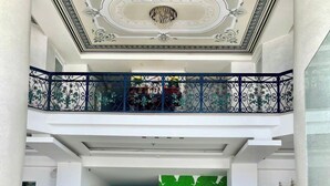 A spacious lobby with a high ceiling, ornate ceiling design, and a balcony with decorative railings. - Palette Muine Boutique Hotel Near Mui Ne Beach (1 Bao Loc)