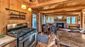 A cozy cabin interior with a kitchen, dining area, and living room. - Creekside Old Tahoe style meets modern cozy Zen Den (Tahoe City)