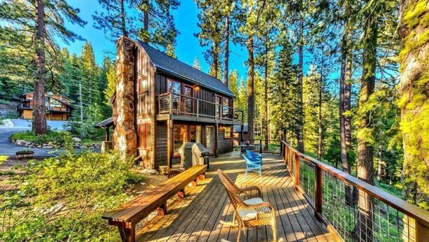 A wooden cabin with a deck, surrounded by tall trees and a clear sky. - Creekside Old Tahoe style meets modern cozy Zen Den (Tahoe City)