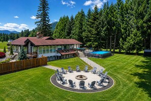A house with a deck, a swimming pool, and a circular seating area with chairs. - Resort-Style Retreat ~ Pool • Hot Tub • Theater • Game Room • Sauna • Acreage (Arlington)