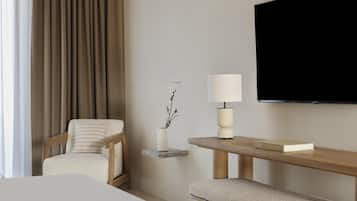 A hotel room with a bed, a chair, a bedside table with a lamp, a small shelf with a plant, and a flat-screen TV mounted on the wall.
